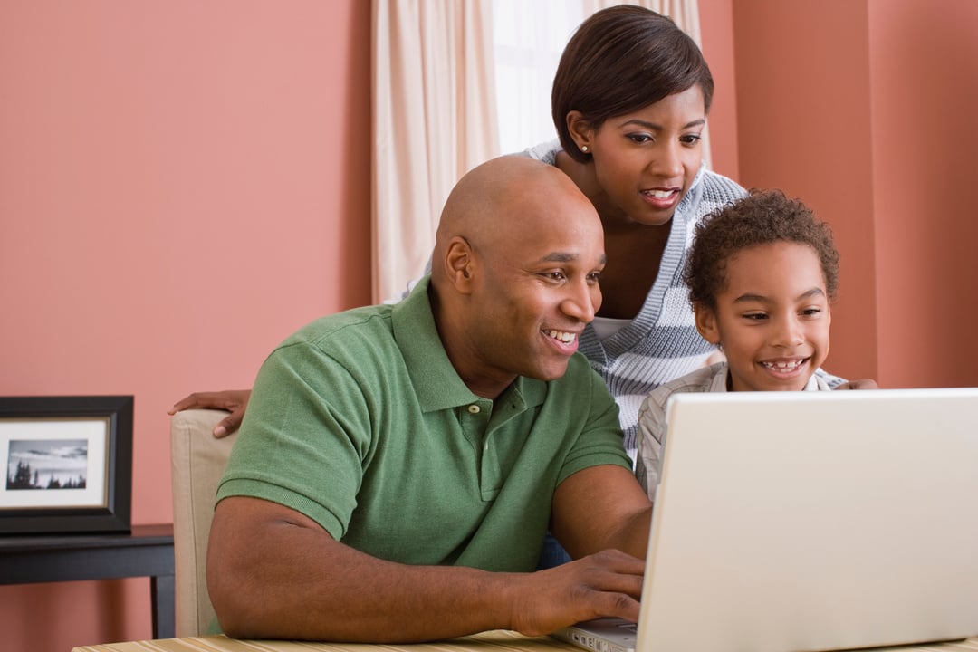 Family using laptop computer